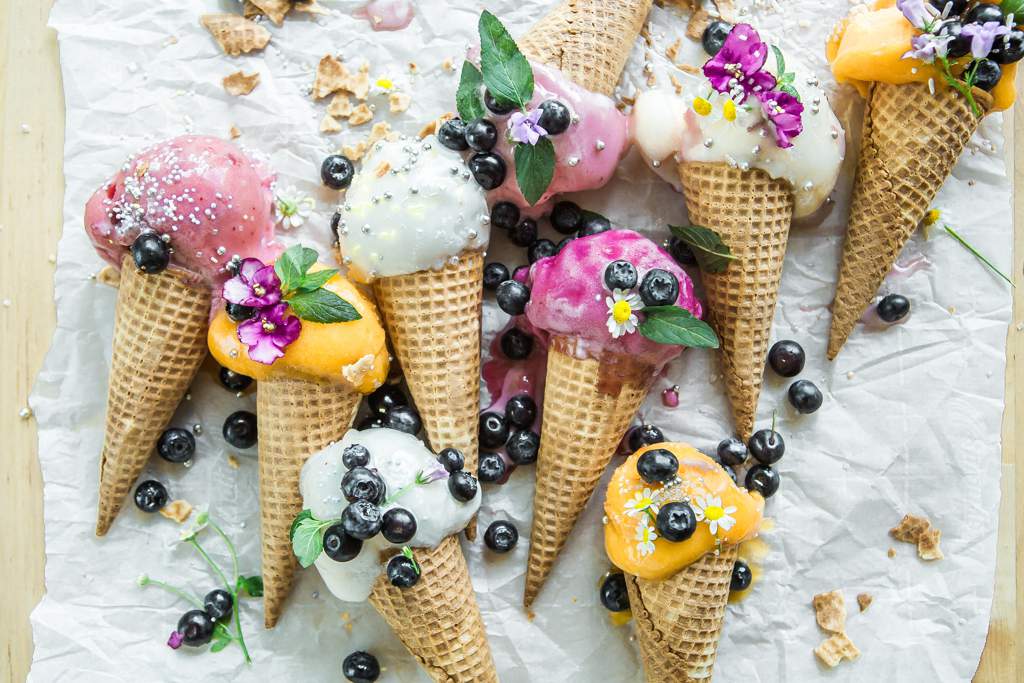 Ice cream cornets decorated with summer fruits
