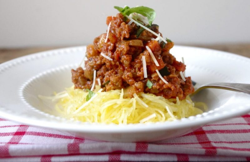 Meat free bolognese on spaghetti squash on a plate.