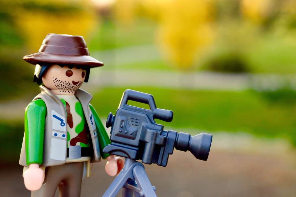 Toy figure with a camera on a tripod